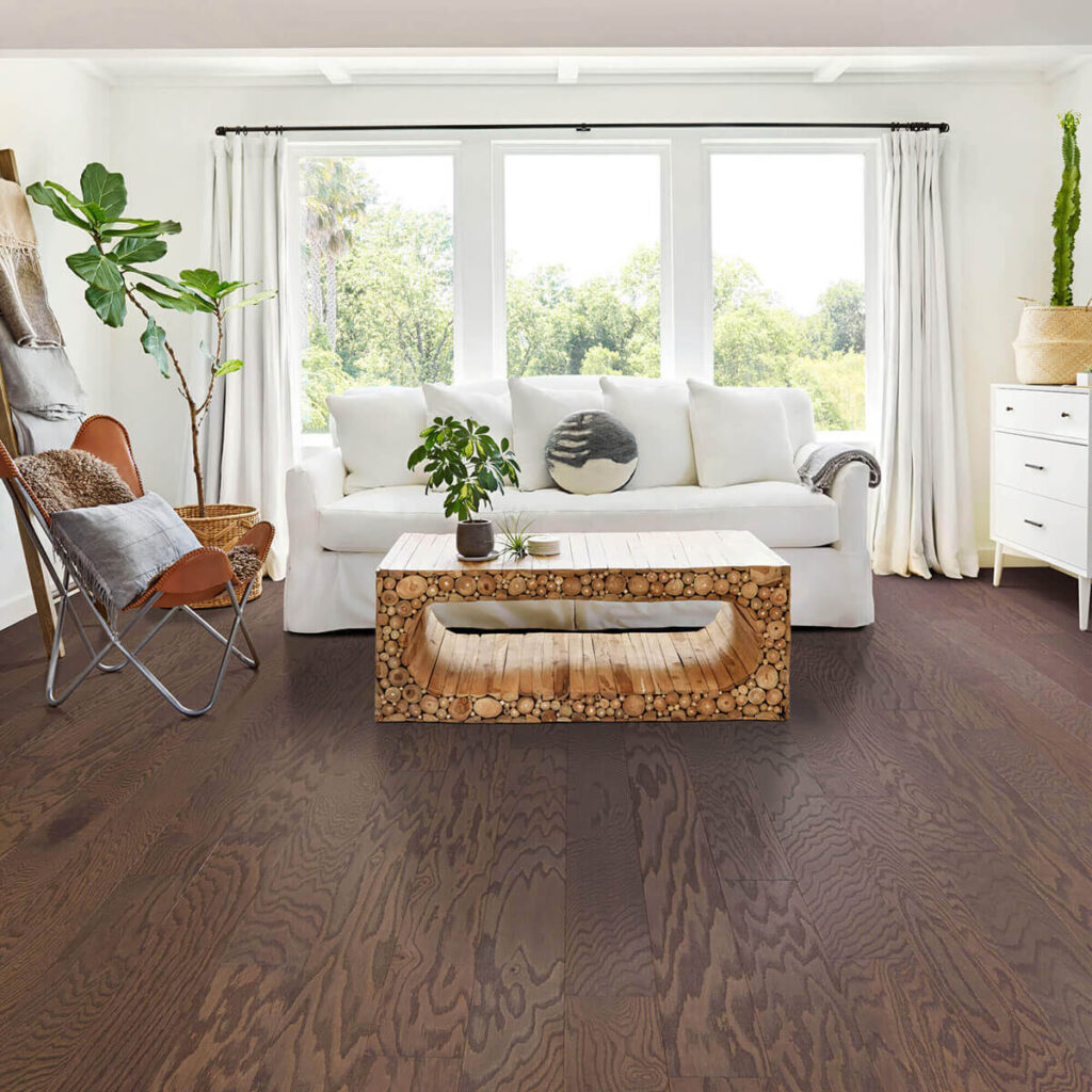 Medium brown hardwood floor in bright living room