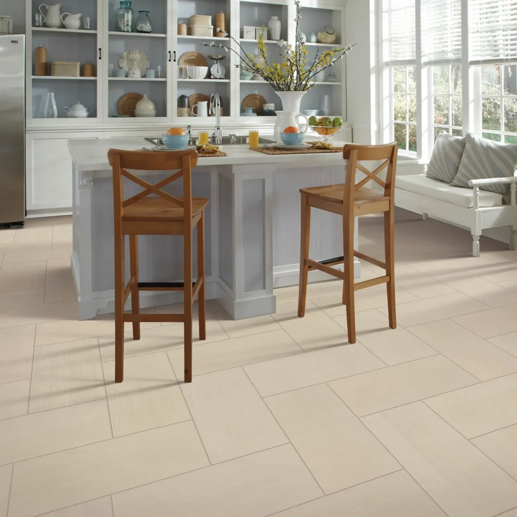 Light beige tile flooring in bright kitchen with island